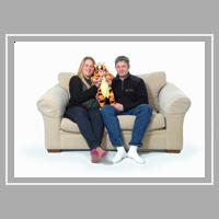 family portrait seated on a sofa